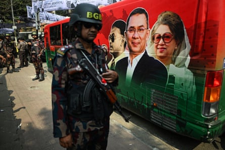 Army personnel stand next to a bus during the Bangladesh election campaign.