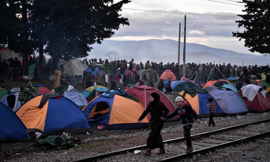 Refugees wait for food at a camp on the Greek-Macedonian border.