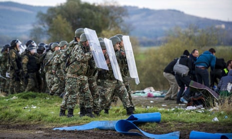 Macedonian police stand guard at the Greek-Macedonian border as migrants and refugees attempt to cross