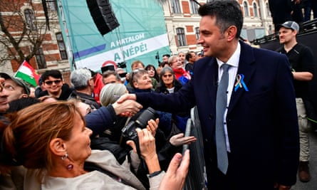 Péter Márki-Zay shakes hands with a supporter during a joint demonstration organised by opposition parties as Hungary’s National Day celebrations.