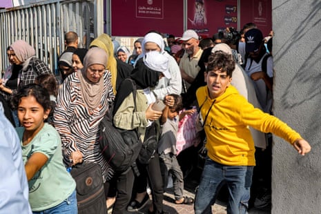People walk through a gate to enter the Rafah crossing to Egypt
