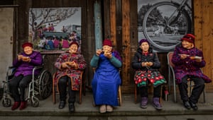 Five older women sit eating