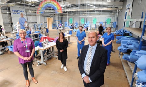 Northumbria Healthcare Trust's PPE manufacturing and distribution hub in Cramlington, with Sir James Mackey on the right.