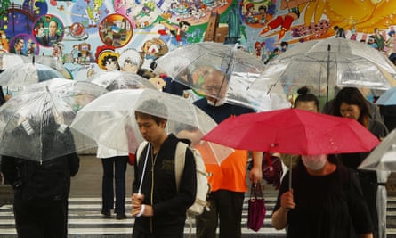 People holding umbrellas as they walk in the rain in Tokyo on Friday