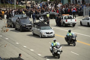 A silver hearse carrying the body of Nipsey Hussle leaves Staples Center Thursday in Los Angeles in a procession following the memorial service for the late rapper.