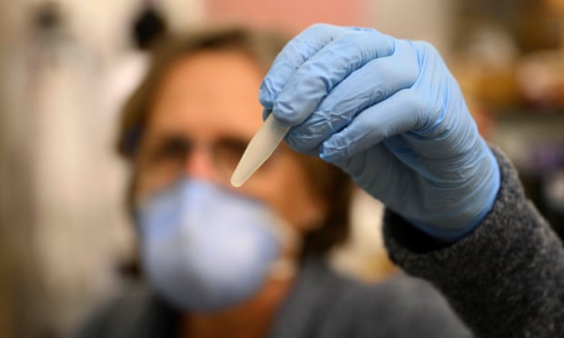 Professor Monica Trujillo holds up a wastewater sample at a lab at Queens College on August 25, 2022. The disease has been detected in New York City sewage.