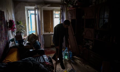 A disabled man walks using crutches in his damaged home following a shelling on the town of Bakhmut in Donetsk region, on 25 October.