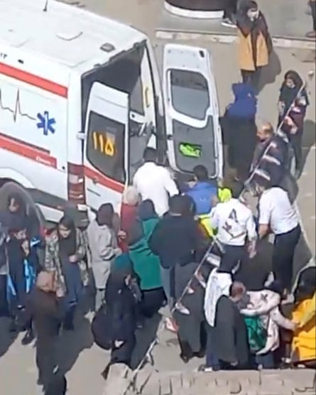 A video grab shows person being lifted into an ambulance outside a girls’ school after reports of poisoning in Ardabil, Iran