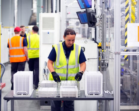 Worker in hi-vis jacket with three others in background