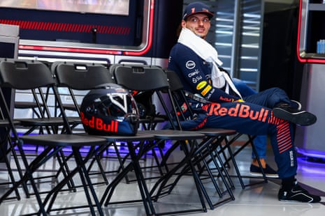 Max Verstappen sits in the garage before the Japan GP with his helmet on a seat next to him