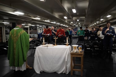 Chaplain Ben Garrett, a Roman Catholic priest, holds a religious service.