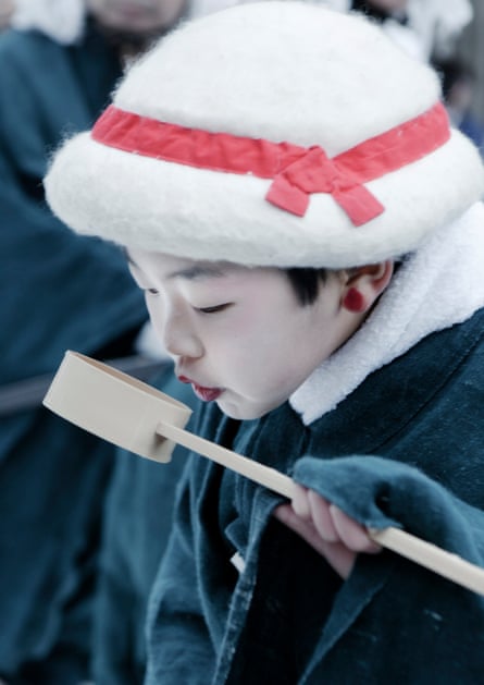 A child drinking water from a chōzuya during the ancient Japanese ritual of zaido