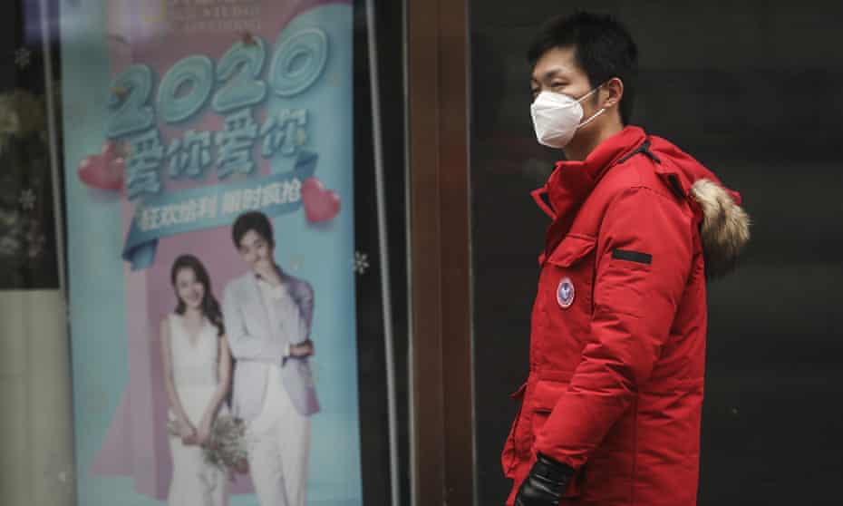 A man wears a mask while walking in the street in Wuhan, China, where the coronavirus was discovered.