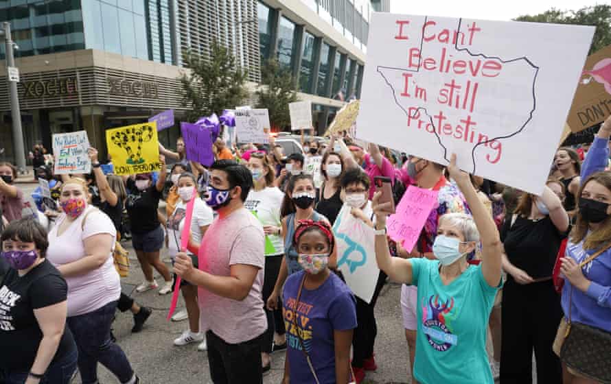 People participate in the Houston Women’s March against the Texas abortion ban on 2 October.