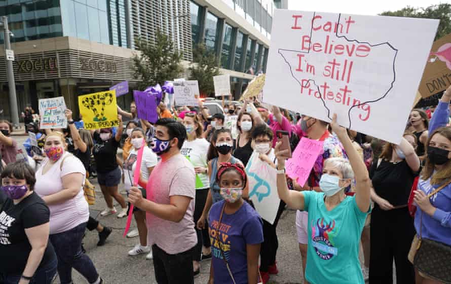 People participate in the Houston Women’s March against the Texas abortion ban on 2 October.