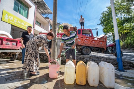 A villager fills up at a water distribution point in Luoping village in south-west China’s Chongqing municipality.