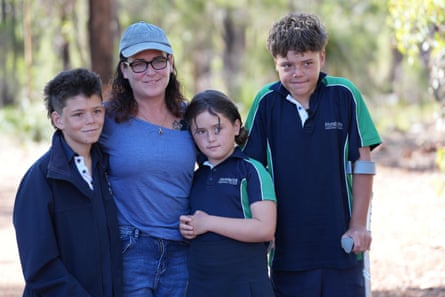 Austin Appelbee, right, with his brother, Beau, left, his mother, Joanne, and sister Grace, in Gidgegannup, Australia, after Austin swam to raise the alarm for his family.