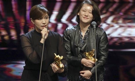 Taiwanese director Fu Yue, left, delivers a speech next to producer Hong Ting Yi after she won Best Documentary at the 55th Golden Horse Awards in Taipei