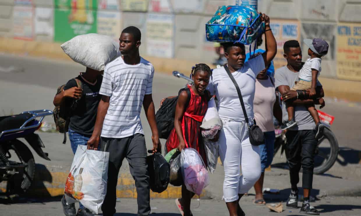Residents of the Solino neighbourhood displaced from their homes due to clashes between armed gangs. Photograph: Odelyn Joseph/AP
