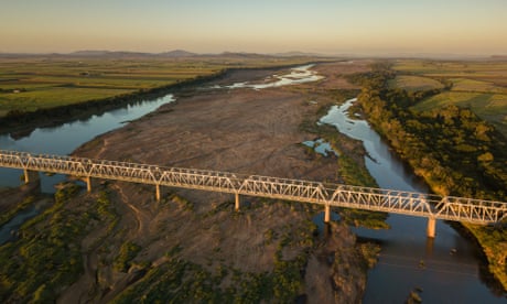 Burdekin Bridge<br>Aerial view of a bridge across a large river in the morning light.