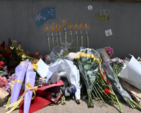 Tributes to victims are seen at the pedestrian bridge used by two gunmen during the Bondi beach terrorist attack in December.