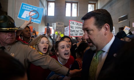 Addie Brue, 16 and Madeline Lederman, 17, shout "do something," with other protesters as Rep. Jeremy Faison, R-Cosby, Chairman of the House Republican Caucus, walks towards the House chamber doors at the State Capitol Building in Nashville , Tenn., Thursday, March 30, 2023. (Nicole Hester/The Tennessean via AP)