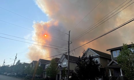 Smoke from the Tantallon wildfire rises over houses in nearby Bedford, Nova Scotia, Canada, on 28 May.