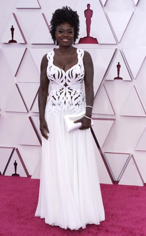 A custom-made, laser-cut, silk white floor-length gown by Alexander McQueen, topped off with a proper updo and matching clutch like it’s 2012. An actual dress befitting of the season and the mood and impossible to sit down in.