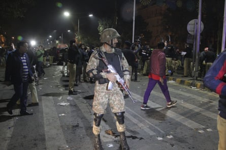 Police and security officers cordon off the scene of the explosion in Lahore.