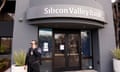 A security guard stands outside of the entrance of the Silicon Valley Bank