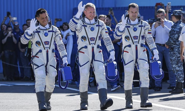 Nasa astronaut Frank Rubio (left) and the Roscosmos cosmonauts, Sergey Prokopyev (centre) and Dmitri Petelin (right), walk to the Soyuz spaceship.
