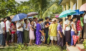 People stand in line at a polling station in North Okkalapa near Yangon on Sunday