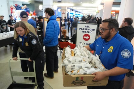 TSA workers collect cheesesteaks at the Philadelphia international airport on 24 March.
