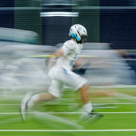 The NFL Academy players warm up before kick off during their match against De La Salle Spartans from California at the Tottenham Hotspur Stadium.