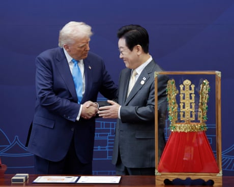 Donald Trump is presented with a crown by South Korean president Lee Jae Myung.