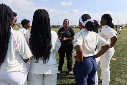 An African coach talks to a team of African teenage girls