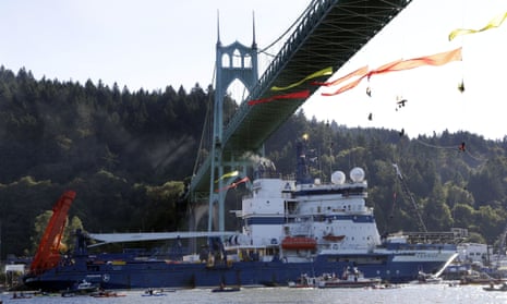 The Royal Dutch Shell icebreaker Fennica heads up the Willamette River under the remaining protesters hanging from the St Johns bridge, en route to Alaska.
