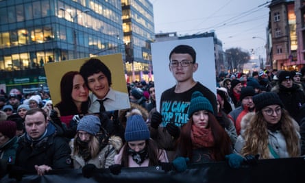 People hold portraits of the journalist Ján Kuciak and his fiancee, Martina Kušnírová, during a silent protest march in their memory in 2018.