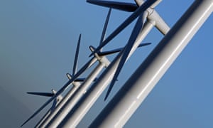close up of white wind turbines against blue sky