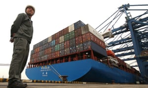Security personnel monitors shipping containers at a port in Dongguan, China.
