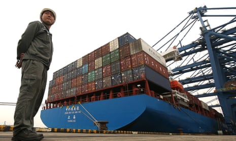 Security personnel monitors shipping containers at a port in Dongguan, China. 