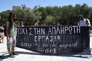 Short-term contract employees of the Culture Ministry, unpaid for over six months, protest outside the entrance of the ancient Acropolis hill in Athens, Thursday, July 23, 2015. Greece’s radical left-led government survived another revolt by rebels in the early hours of Thursday, passing reforms that should pave the way for the imminent start of bailout discussions with European creditors. Sign says in Greek and English “Say no to the unpaid work.” (AP Photo/Giannis Papanikos)