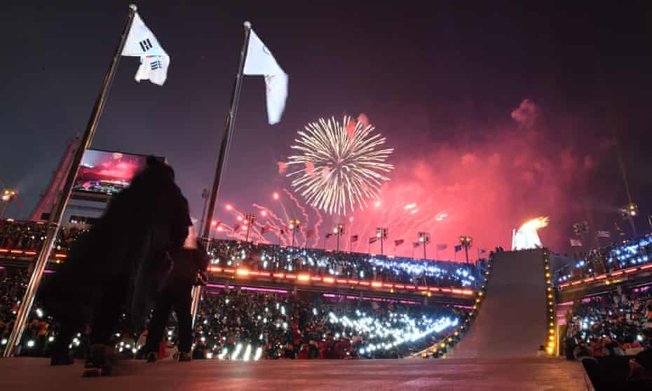 Fireworks explode as the Olympic flame burns during the opening ceremony of the Pyeongchang Games.