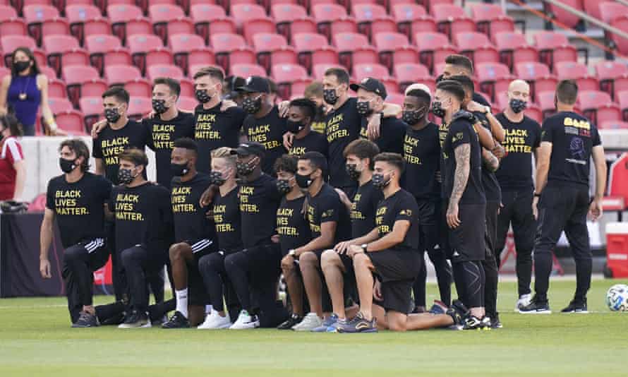 Players from Los Angeles FC pose for a group photo on the field prior to the announcement that their game against Real Salt Lake was called off on Wednesday.