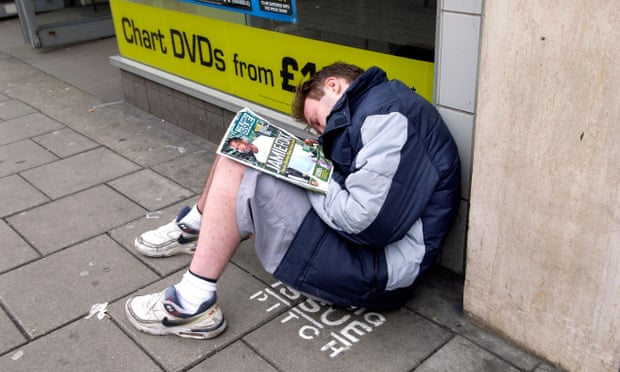 A Big Issue seller asleep on his pitch