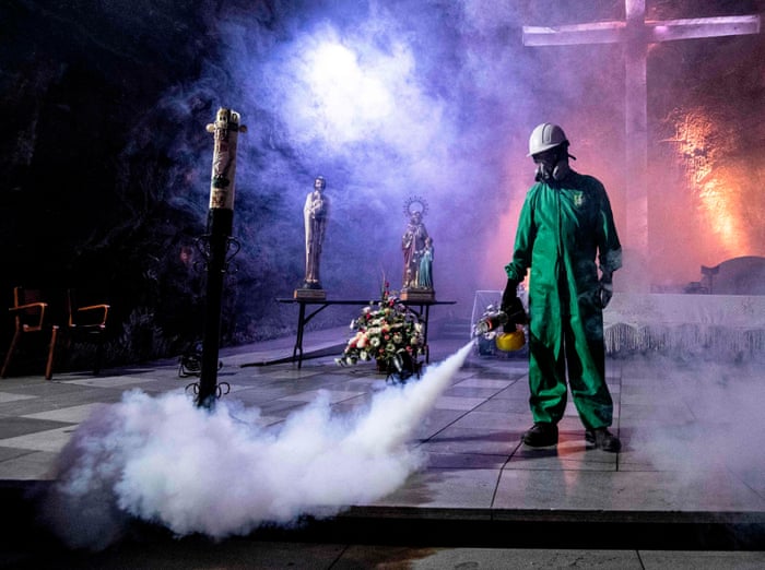 A worker disinfects the Salt Cathedral of Zipaquira, an underground church built into a salt mine, in Zipaquira, 45 km north of Bogota, on 30 August, 2020, during the coronavirus pandemic.