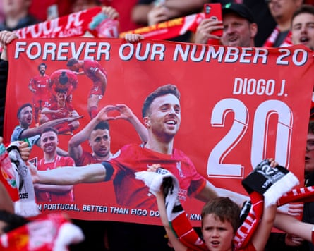 Liverpool fans hold up a banner in tribute to Diogo Jota.