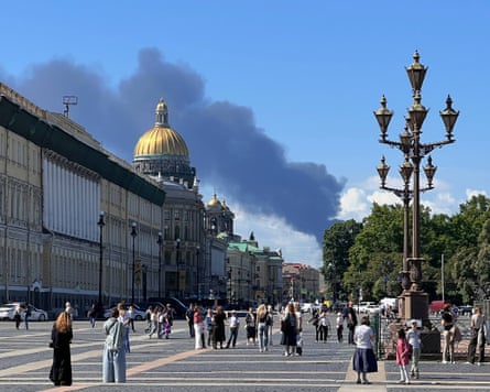 Black smoke seen in the distance from a wide road junction in central St Petersburg