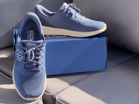 Blue Kizik Lima 2 sneakers next to box on couch