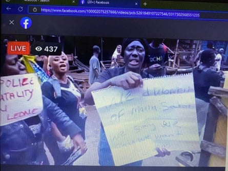 A screengrab of a live feed of protests that was broadcast on Facebook, showing women holding up signs to the camera